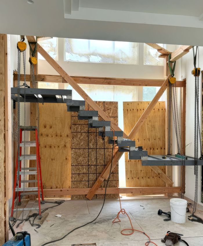 Metal support stairs to second floor are being installed in new building